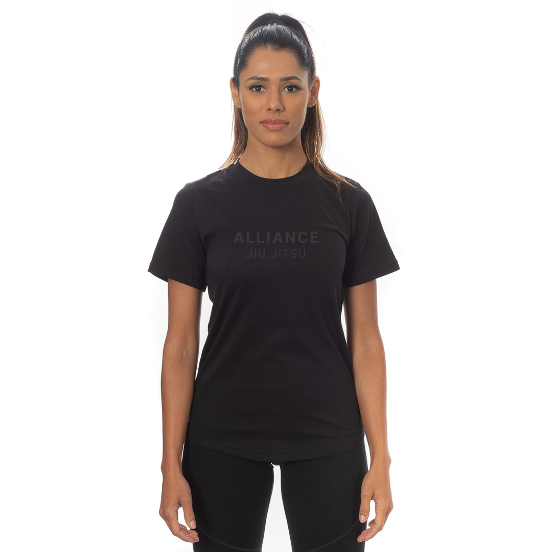 Woman wearing a black t-shirt with 'ALLIANCE' branding on a white background